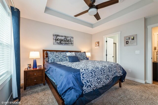 2401 E 50th St, Des Moines, IA 50317 - bedroom featuring carpet floors, a raised ceiling, and a ceiling fan