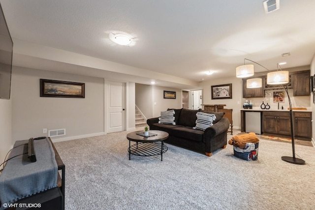 2401 E 50th St, Des Moines, IA 50317 - living area with light carpet and stairway