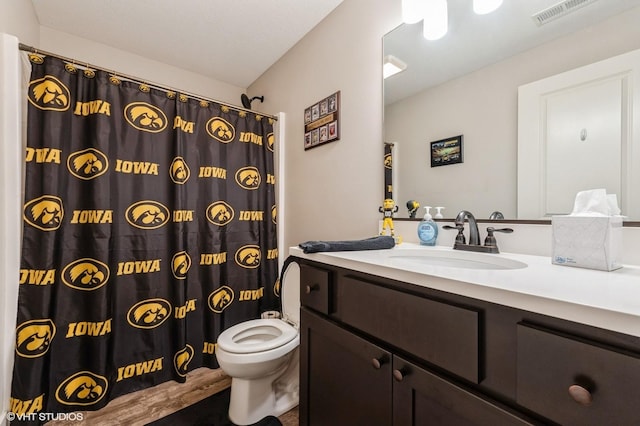 2401 E 50th St, Des Moines, IA 50317 - full bathroom with vanity, a shower with curtain, and wood finished floors