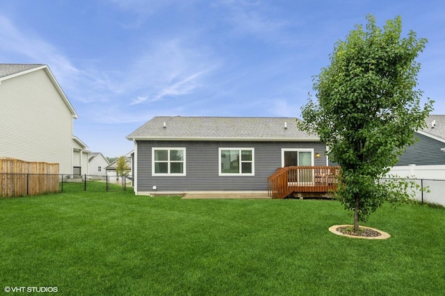 2401 E 50th St, Des Moines, IA 50317 - rear view of house featuring a fenced backyard, a wooden deck, and a shingled roof