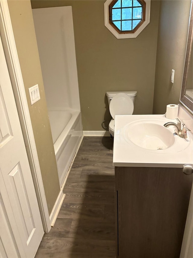 3112 52nd St, Des Moines, IA 50310 - full bath with vanity, a bath, and wood finished floors