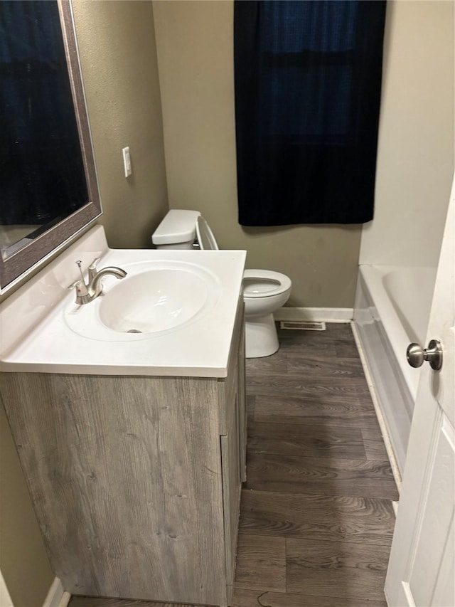 3112 52nd St, Des Moines, IA 50310 - full bath featuring vanity, a tub to relax in, wood finished floors, and a shower