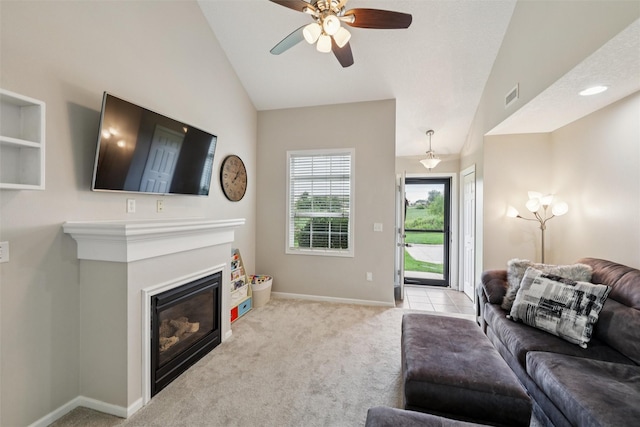 601 Orchard Hills Dr Unit 7006, Norwalk, IA 50211 - carpeted living area with a ceiling fan, vaulted ceiling, and a glass covered fireplace