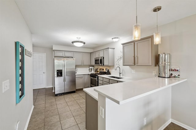 601 Orchard Hills Dr Unit 7006, Norwalk, IA 50211 - kitchen with stainless steel appliances, gray cabinets, a peninsula, light countertops, and hanging light fixtures