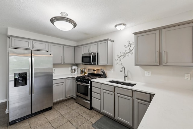 601 Orchard Hills Dr Unit 7006, Norwalk, IA 50211 - kitchen featuring stainless steel appliances, gray cabinets, light countertops, a textured ceiling, and light tile patterned floors