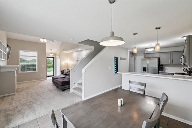 601 Orchard Hills Dr Unit 7006, Norwalk, IA 50211 - dining area featuring ceiling fan, stairway, carpet floors, and tile patterned floors