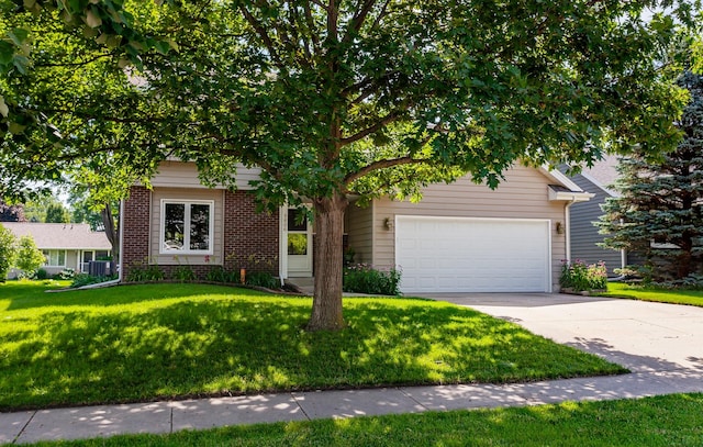 3806 Columbine Ave, Ames, IA 50010 - view of property hidden behind natural elements with a garage, brick siding, concrete driveway, and a front lawn