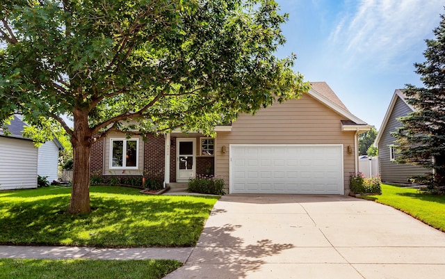 3806 Columbine Ave, Ames, IA 50010 - view of property hidden behind natural elements with a garage, concrete driveway, a front yard, and brick siding