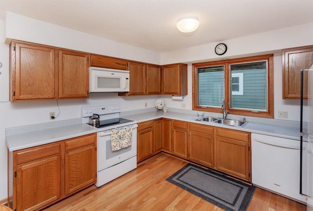 3806 Columbine Ave, Ames, IA 50010 - kitchen with white appliances, light wood-style flooring, light countertops, and brown cabinets