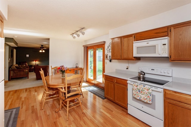 3806 Columbine Ave, Ames, IA 50010 - kitchen featuring white appliances, light wood-type flooring, light countertops, and brown cabinetry