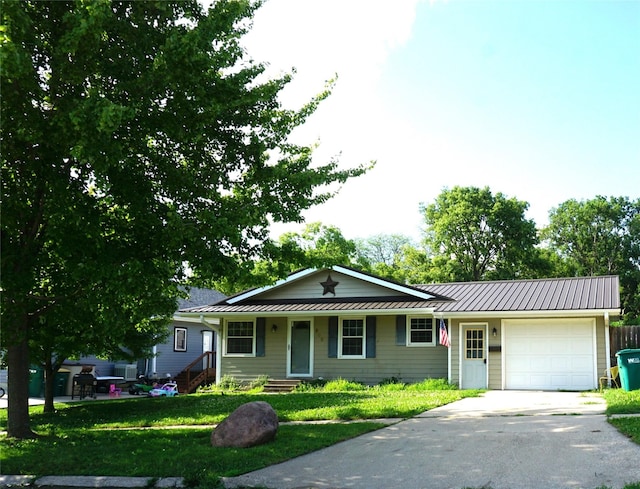 609 E Filmore St, Winterset, IA 50273 - single story home featuring an attached garage, driveway, a metal roof, and a standing seam roof