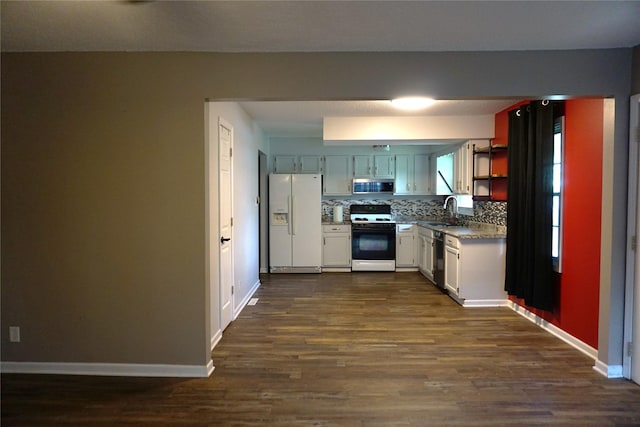 609 E Filmore St, Winterset, IA 50273 - kitchen featuring white appliances, dark wood-type flooring, decorative backsplash, and open shelves
