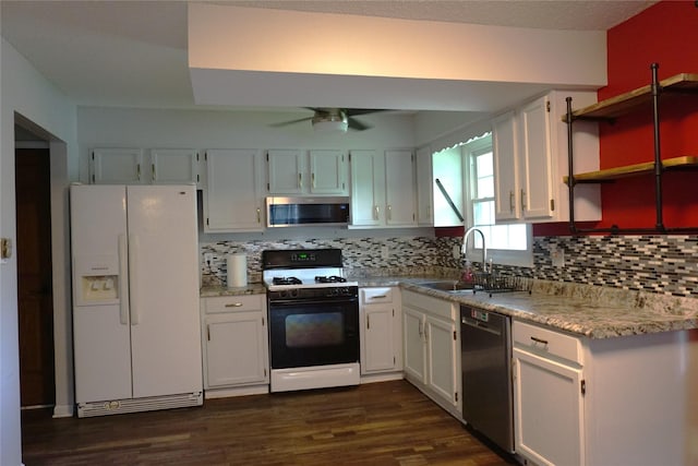 609 E Filmore St, Winterset, IA 50273 - kitchen featuring appliances with stainless steel finishes, white cabinets, decorative backsplash, and open shelves