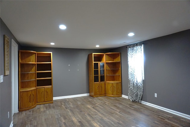 609 E Filmore St, Winterset, IA 50273 - unfurnished living room featuring wood finished floors and recessed lighting