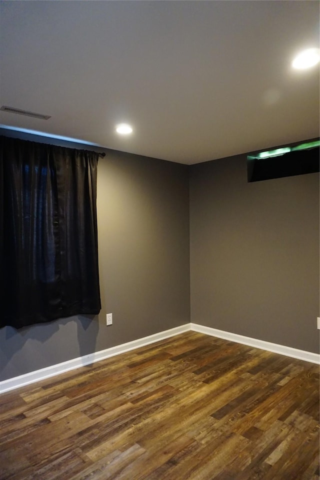 609 E Filmore St, Winterset, IA 50273 - spare room with dark wood-type flooring and recessed lighting