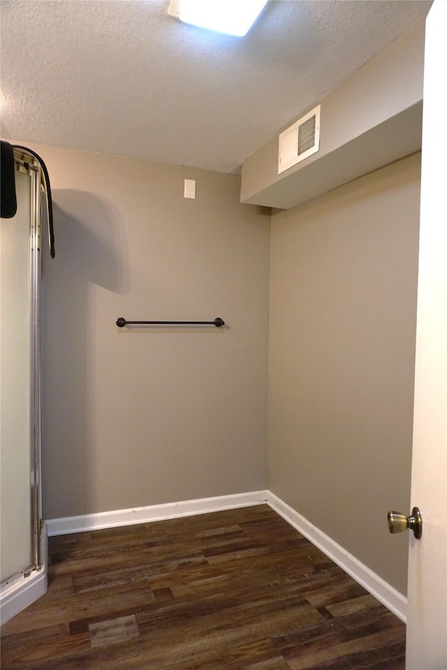 609 E Filmore St, Winterset, IA 50273 - finished below grade area with dark wood-type flooring and a textured ceiling