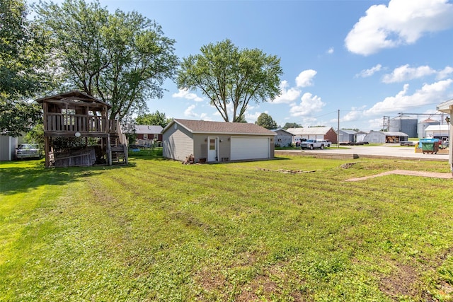 208 SW 4th St, Ogden, IA 50212 - view of grassy yard featuring stairs, a garage, a wooden deck, and an outdoor structure
