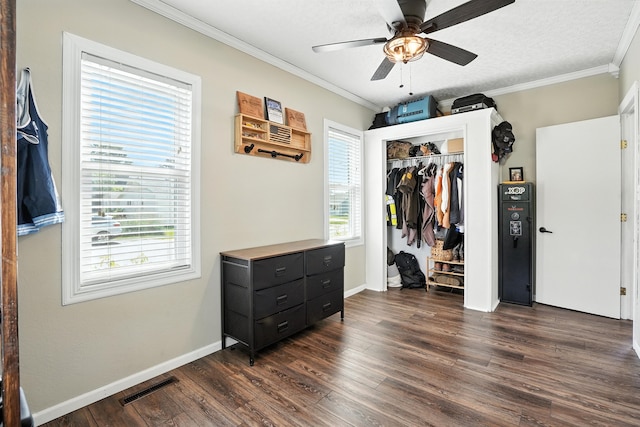 510 Maple Ave, Woodward, IA 50276 - bedroom with ornamental molding, dark wood-style floors, a closet, and a ceiling fan