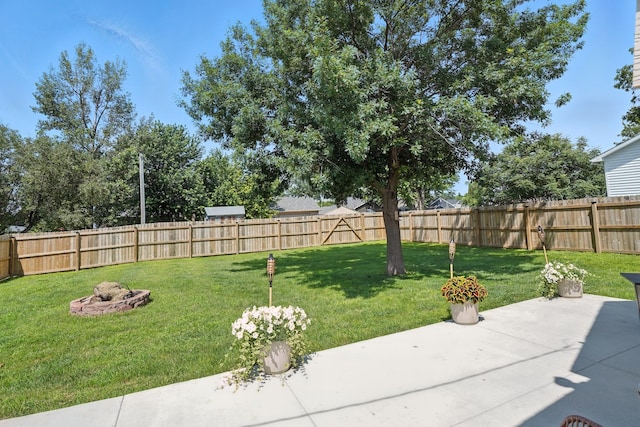 510 Maple Ave, Woodward, IA 50276 - fenced backyard with a patio area and a fire pit