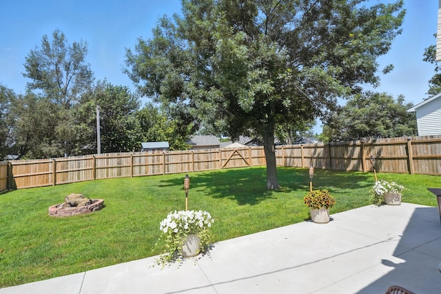 510 Maple Ave, Woodward, IA 50276 - fenced backyard with a patio and an outdoor fire pit
