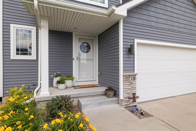 2718 NW 23rd St, Ankeny, IA 50023 - doorway to property with a garage and covered porch