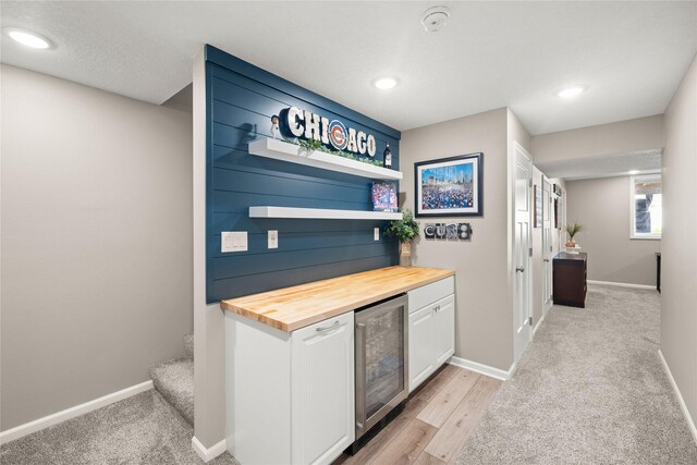 2718 NW 23rd St, Ankeny, IA 50023 - indoor dry bar featuring beverage cooler, recessed lighting, and light carpet