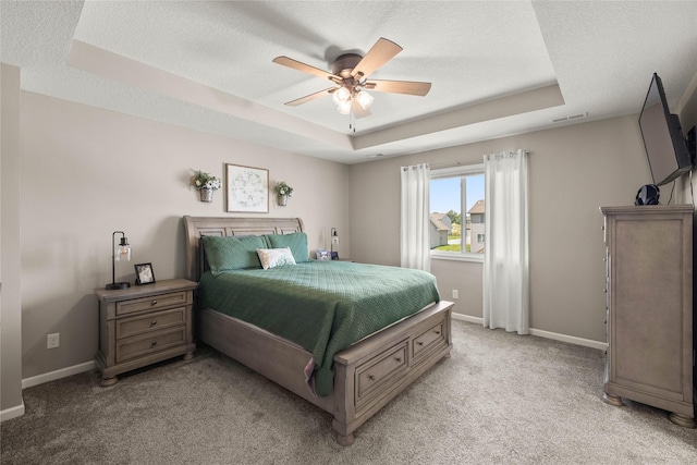 2718 NW 23rd St, Ankeny, IA 50023 - bedroom with a tray ceiling, light carpet, a ceiling fan, and a textured ceiling