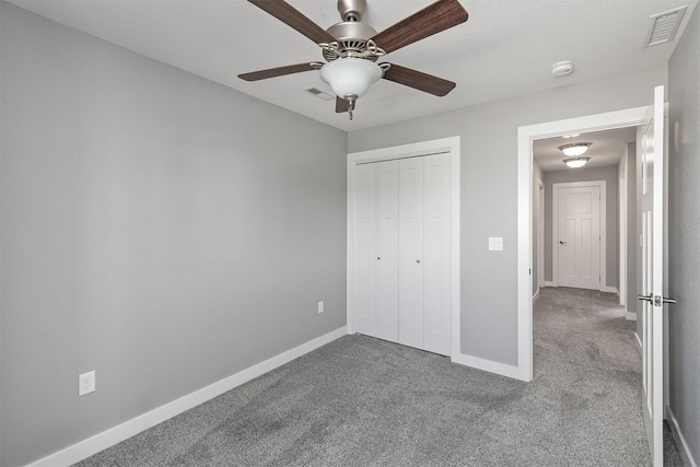 2017 NE Heritage Dr, Grimes, IA 50111 - unfurnished bedroom featuring carpet flooring, a closet, and a ceiling fan