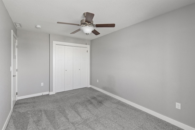 2017 NE Heritage Dr, Grimes, IA 50111 - unfurnished bedroom with carpet, a closet, ceiling fan, and a textured ceiling