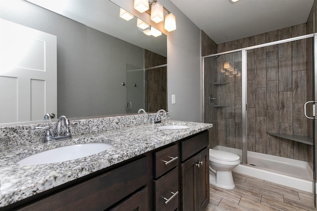 2017 NE Heritage Dr, Grimes, IA 50111 - full bath with double vanity, a shower stall, and wood finished floors