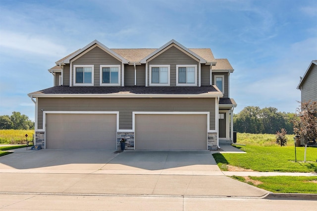 2017 NE Heritage Dr, Grimes, IA 50111 - view of front of home with a garage, a front yard, concrete driveway, and stone siding