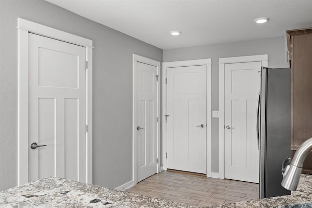 2017 NE Heritage Dr, Grimes, IA 50111 - unfurnished bedroom featuring freestanding refrigerator, light wood finished floors, and recessed lighting