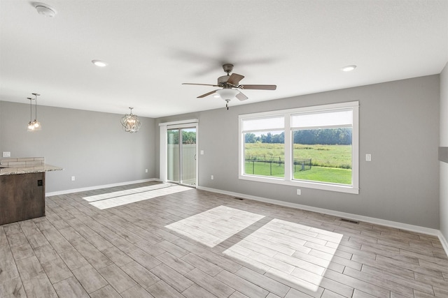 2017 NE Heritage Dr, Grimes, IA 50111 - unfurnished living room with a ceiling fan, light wood-type flooring, and recessed lighting