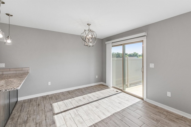 2017 NE Heritage Dr, Grimes, IA 50111 - unfurnished dining area with light wood-type flooring and a chandelier