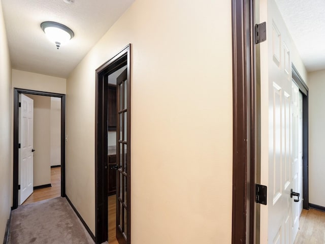 1509 Del Matro Ct, Windsor Heights, IA 50324 - hallway featuring light wood-style flooring and a textured ceiling