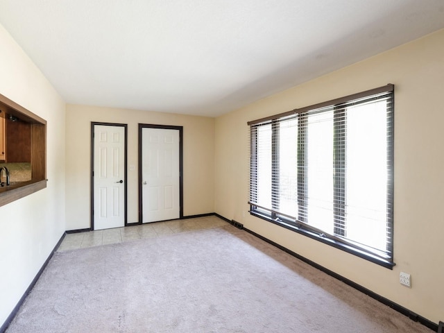 1509 Del Matro Ct, Windsor Heights, IA 50324 - unfurnished bedroom with baseboards and light colored carpet