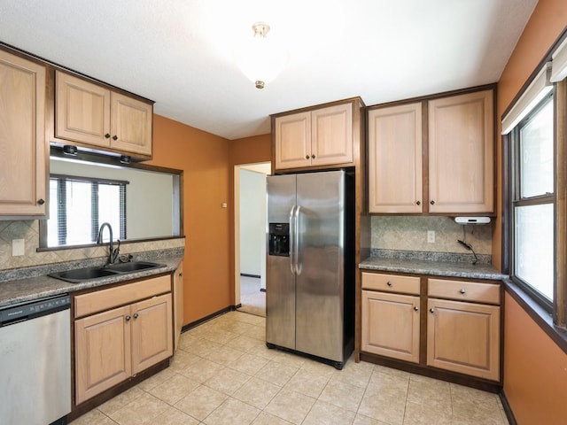 1509 Del Matro Ct, Windsor Heights, IA 50324 - kitchen featuring appliances with stainless steel finishes, tasteful backsplash, healthy amount of natural light, and light tile patterned flooring