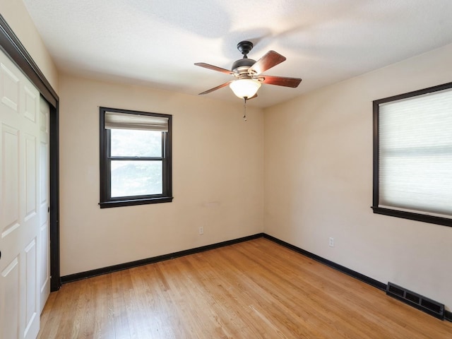 1509 Del Matro Ct, Windsor Heights, IA 50324 - unfurnished room with light wood-type flooring and a ceiling fan