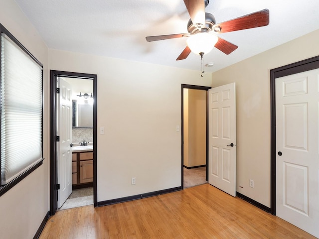 1509 Del Matro Ct, Windsor Heights, IA 50324 - unfurnished bedroom featuring light wood finished floors, ensuite bathroom, and a ceiling fan