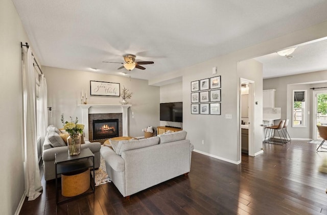 145 SE Kellerman Ln, Waukee, IA 50263 - living area with dark wood-style floors, ceiling fan, and a tile fireplace