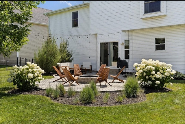 145 SE Kellerman Ln, Waukee, IA 50263 - back of house featuring an outdoor fire pit and a patio
