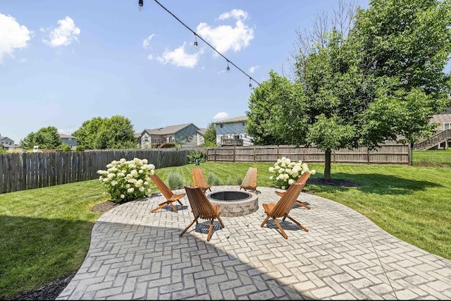 145 SE Kellerman Ln, Waukee, IA 50263 - fenced backyard featuring a fire pit and a patio
