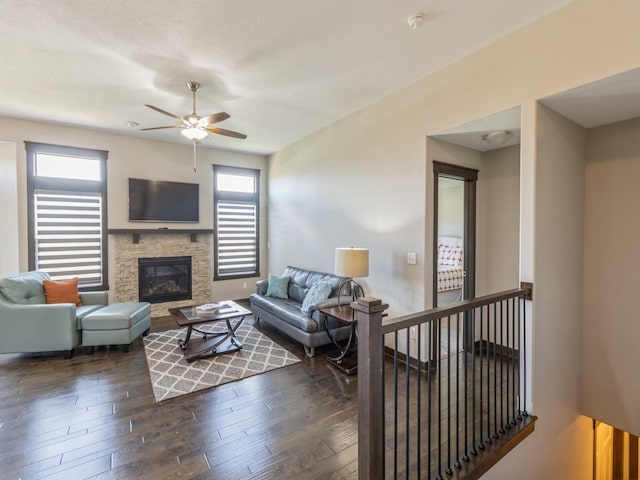 8955 Jamison Dr, West Des Moines, IA 50266 - living room with ceiling fan, a stone fireplace, and dark wood finished floors