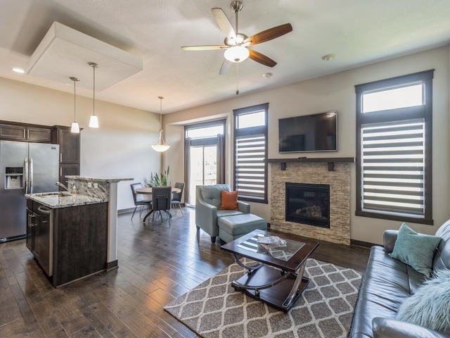 8955 Jamison Dr, West Des Moines, IA 50266 - living room with ceiling fan, a fireplace, and dark wood-type flooring