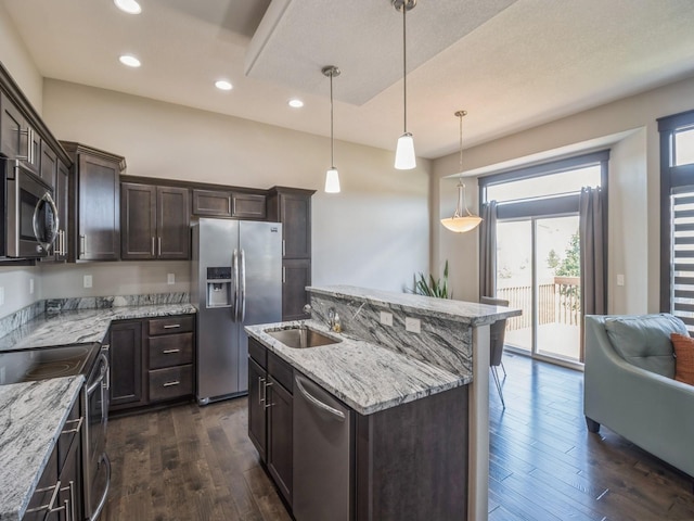 8955 Jamison Dr, West Des Moines, IA 50266 - kitchen with stainless steel appliances, dark brown cabinets, dark wood finished floors, a center island with sink, and recessed lighting