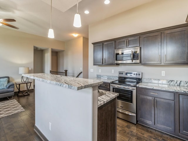 8955 Jamison Dr, West Des Moines, IA 50266 - kitchen with stainless steel appliances, dark brown cabinets, a center island, a ceiling fan, and pendant lighting
