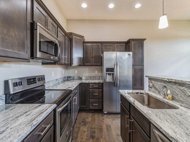 8955 Jamison Dr, West Des Moines, IA 50266 - kitchen featuring stainless steel appliances, dark brown cabinets, dark wood finished floors, recessed lighting, and light stone counters
