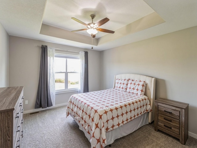 8955 Jamison Dr, West Des Moines, IA 50266 - carpeted bedroom with a raised ceiling and a ceiling fan