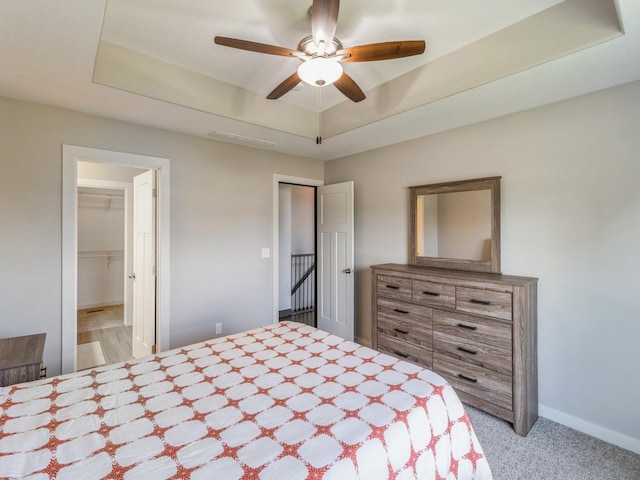 8955 Jamison Dr, West Des Moines, IA 50266 - bedroom with light colored carpet, a raised ceiling, and a ceiling fan