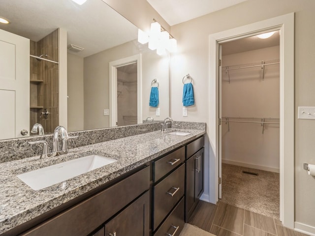 8955 Jamison Dr, West Des Moines, IA 50266 - full bathroom with double vanity, a spacious closet, and a shower